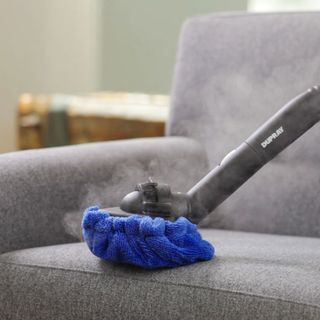 Duprey steam cleaner in use on a sofa