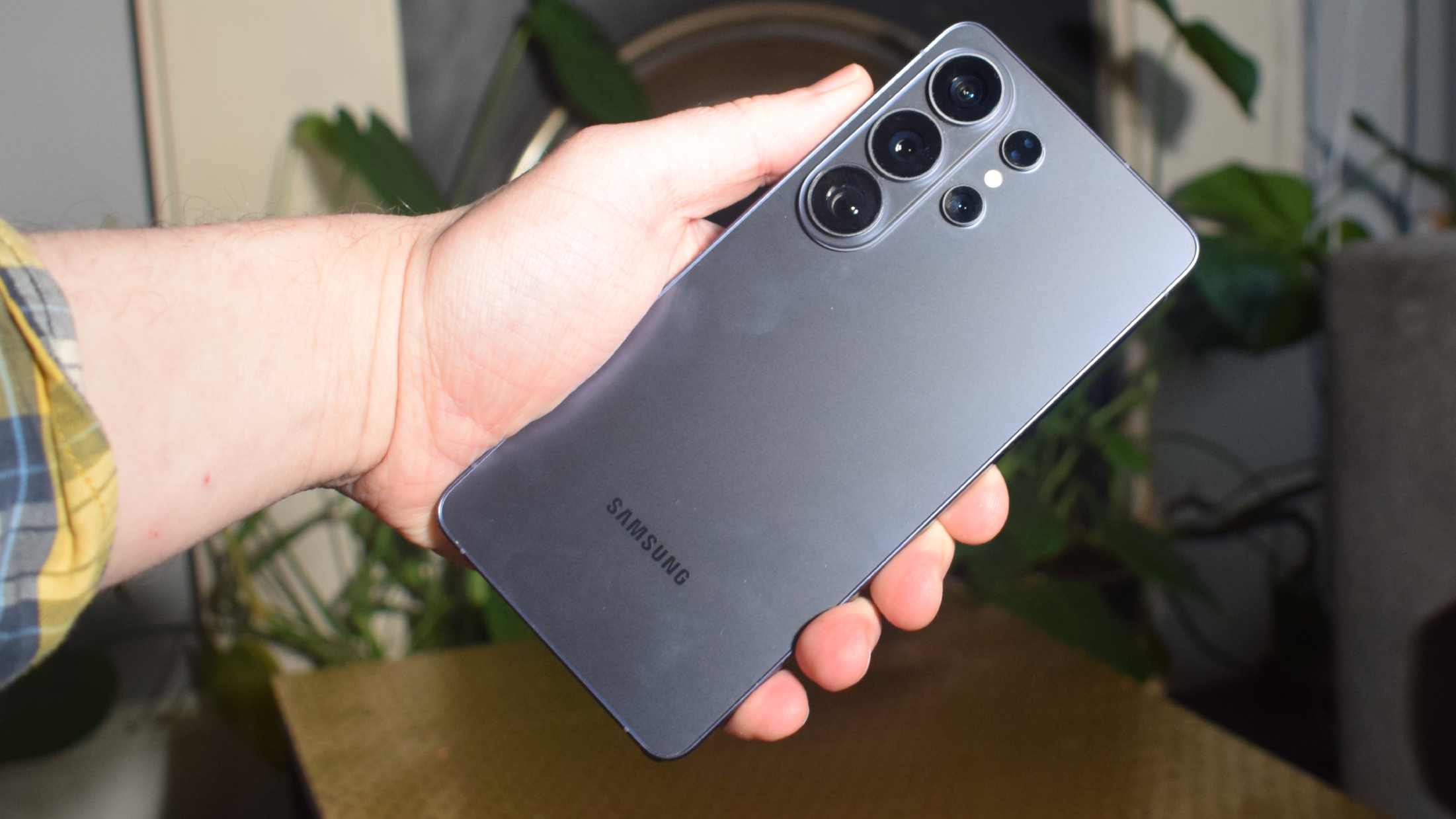 The Samsung Galaxy S26 Ultra in a man's hand, showing its rear.