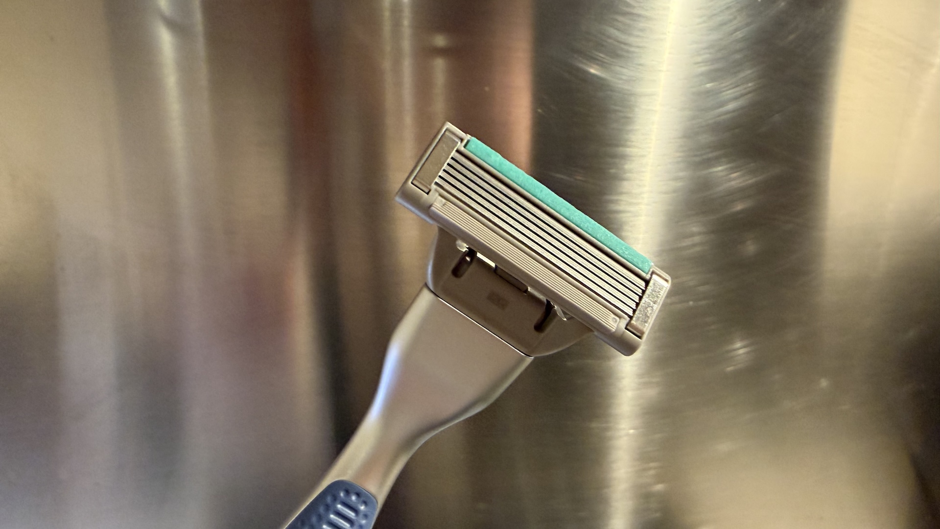 The Harry&#039;s Plus Razor against a stainless steel background
