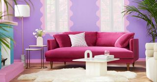 a pink sofa in a purple living room