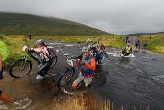 Riders cross a river in the TransWales