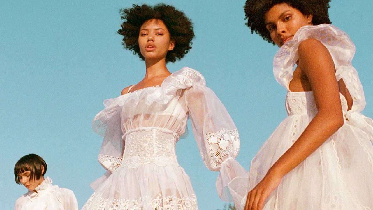 three women in white linen dresses