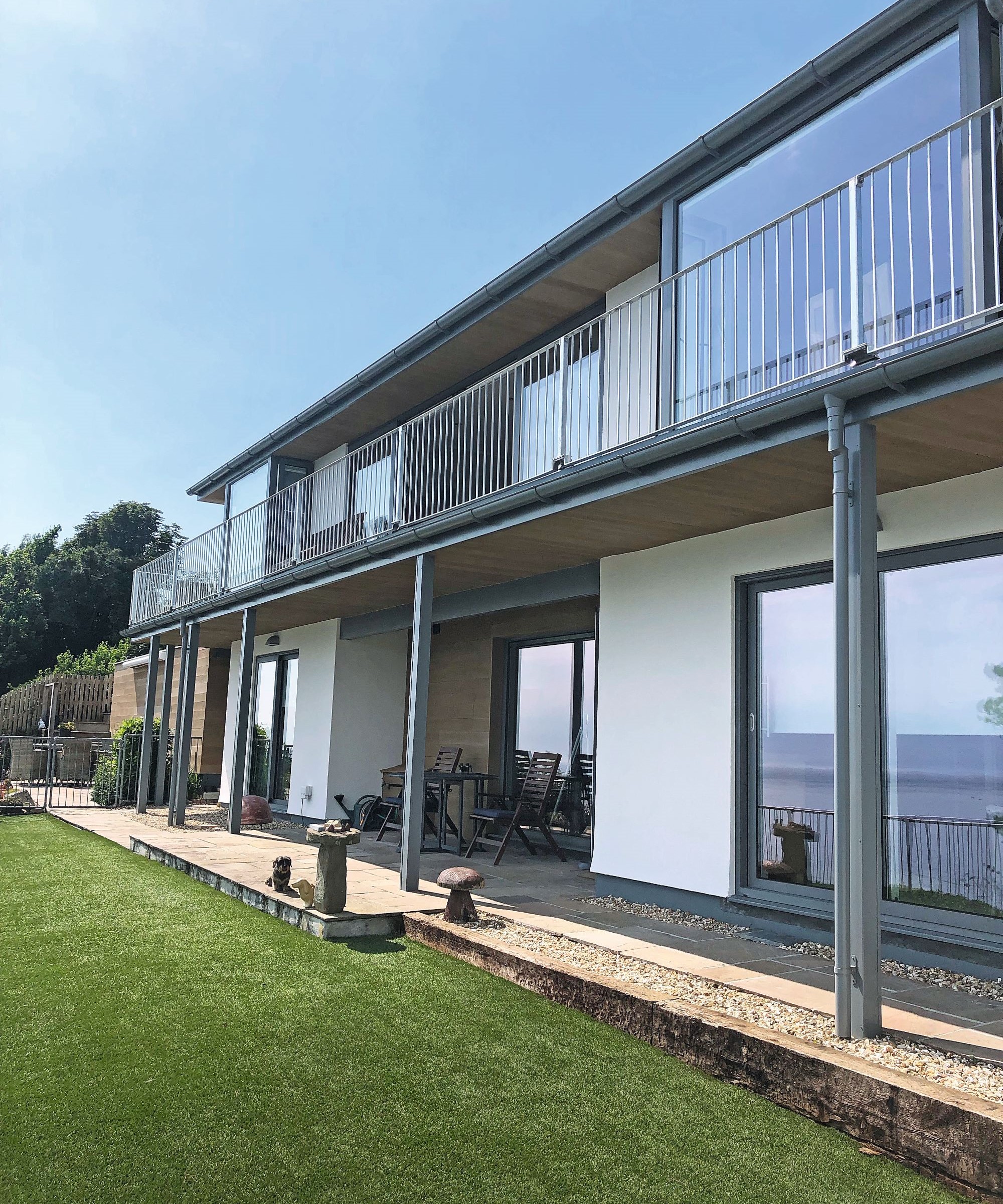 A home with a mix of render, glass and wood clad on the exterior