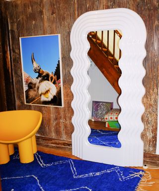 a wavy mirror in a colorful room inspired by the carnivalcore trend