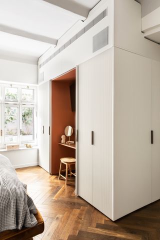 a bedroom vanity in a closet with an orange surround