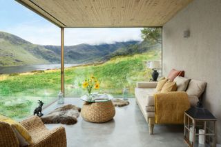 a living room with a panoramic view onto the landscape