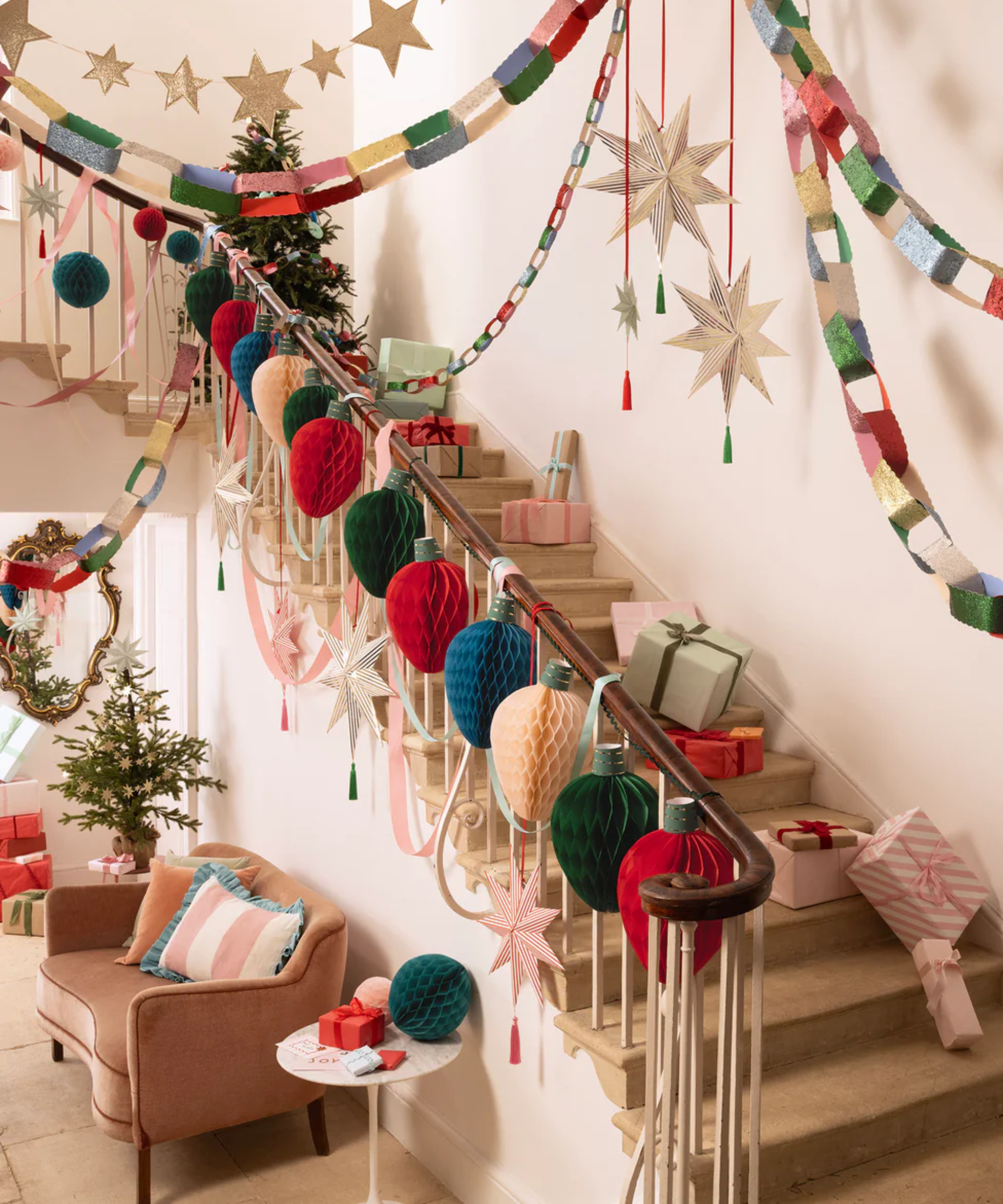 an elaborately decorated staircase with lots of paper Christmas decor