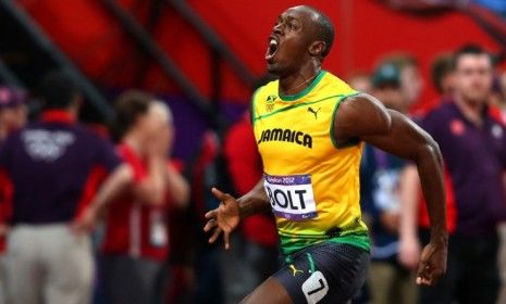 Jamaica&amp;#039;s Usain Bolt celebrates his gold in the Men&amp;#039;s 100m, Aug. 5