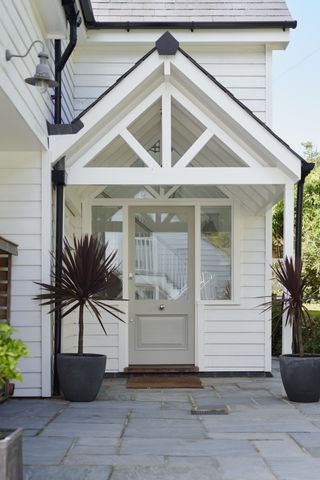 white new england style porch extension to remodelled bungalow