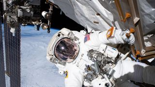 NASA astronaut Andrew Morgan holds on to a handrail during the second spacewalk to repair the International Space Station's cosmic particle detector, the Alpha Magnetic Spectrometer, on Nov. 22, 2019.