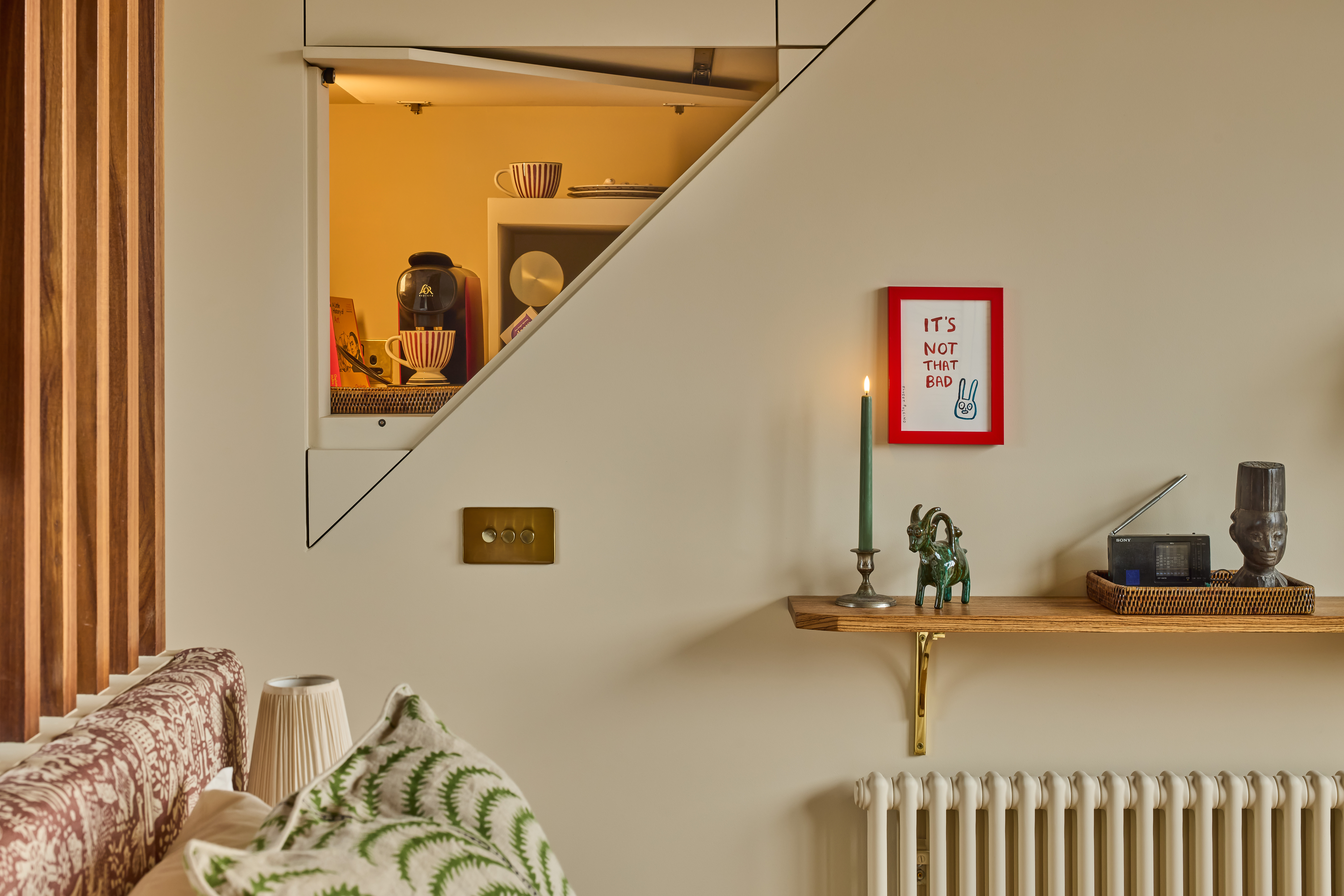 A hidden coffee station in the wall in a bedroom