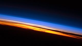 Photograph of the thin band of blue which is our atmosphere, against the black background of space.