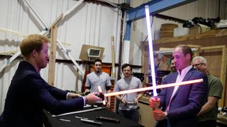 Princes William and Harry fight with lightsabres