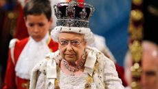 Queen Elizabeth II, wearing the Imperial State Crown, proceeds through the Royal Gallery during the State Opening of Parliament at the Palace of Westminster in central London on May 27, 2015