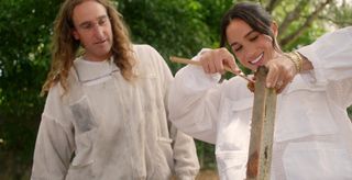 Meghan Markle collects honey in a beekeeping outfit