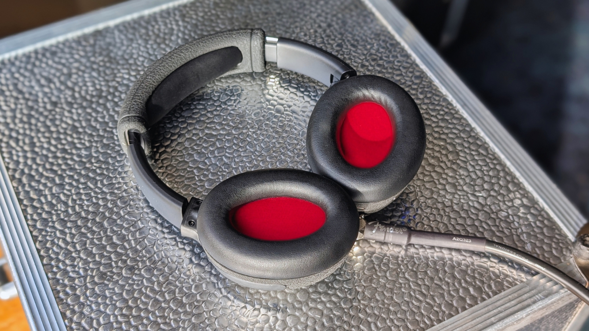 A pair of Positive Grid Spark Neo Core lying on a silver flight case