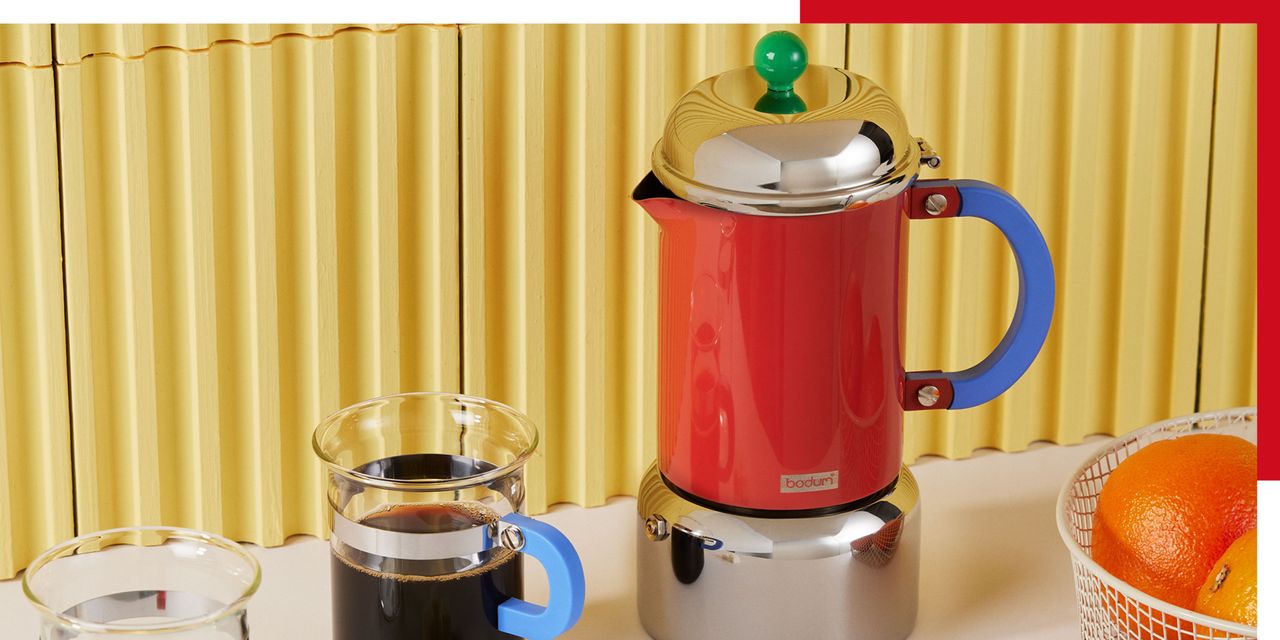 a red, green and blue retro cafetiere on a yellow tile background