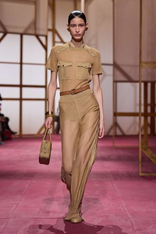 Hermès model at the S/S 25 runway show in Paris wearing a camel-colored monochrome look.