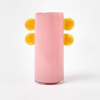 A pink and yellow vase with sculptural details