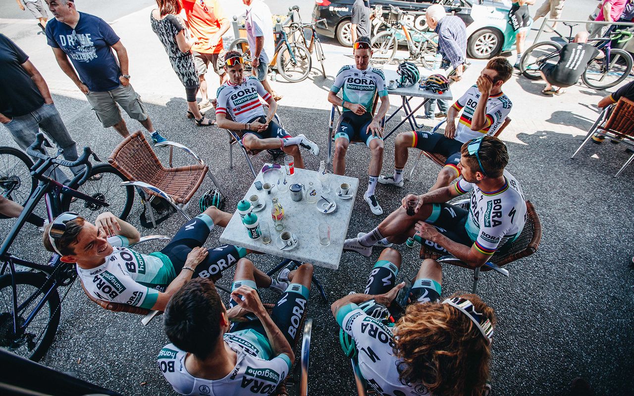 The Bora-hansgrohe Tour de France team enjoy a coffee stop on the first rest day of the 2019 Tour de France