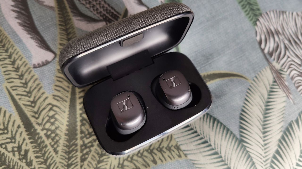 Sennheiser Momentum True Wireless 3 review: headphones in their case on a green background