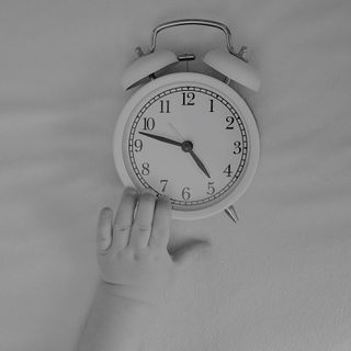 Baby reaching for clock