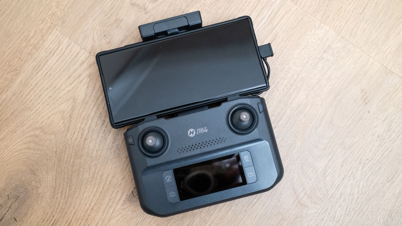 Holy Stone HS600D drone controller on a wooden floor