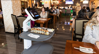 The LG ServeBot delivers food in a Korean BBQ restaurant.
