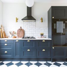 black kitchen with chequerboard floor
