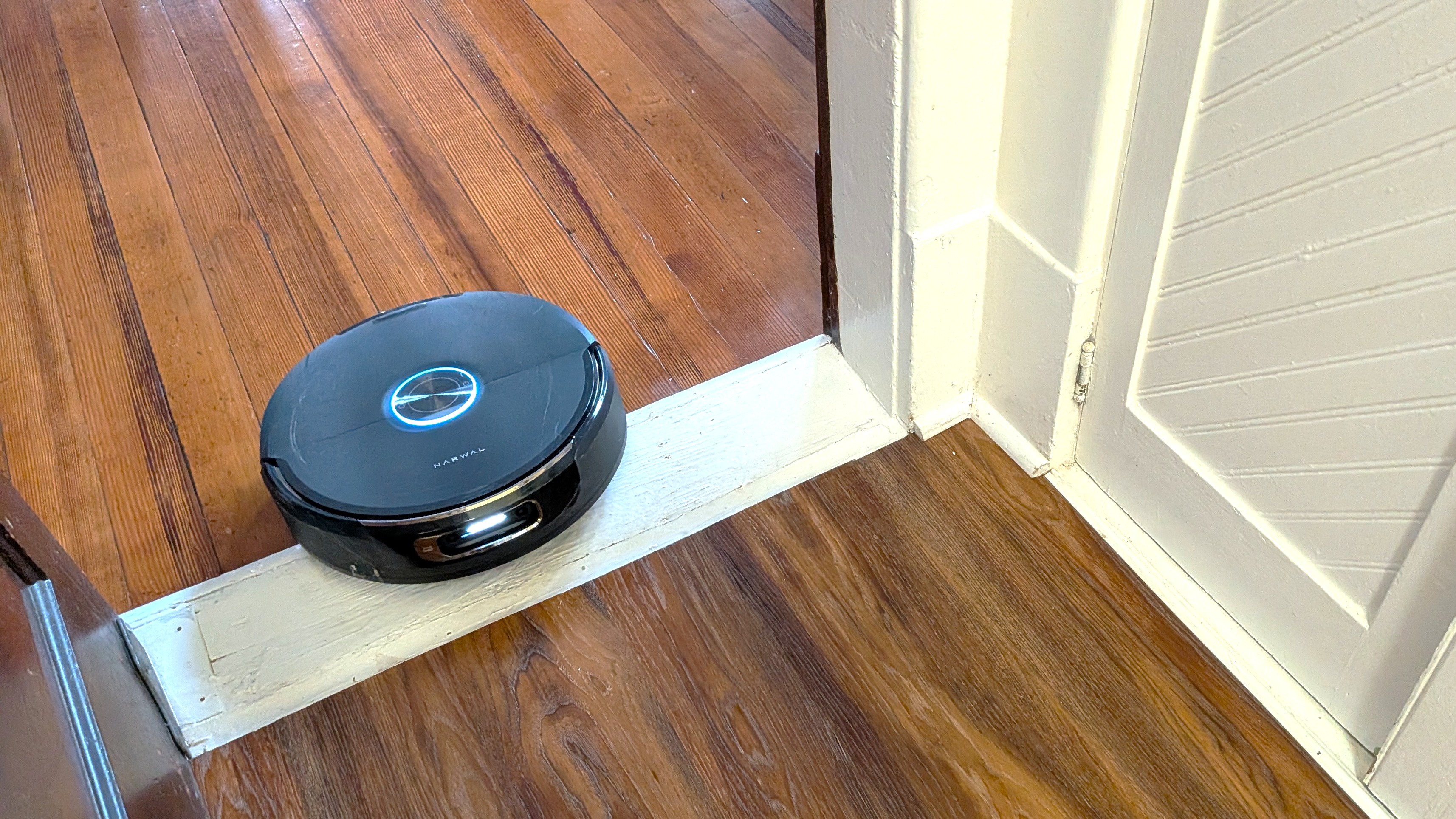 Narwal Flow 2 robot vacuum rolling over door lintel