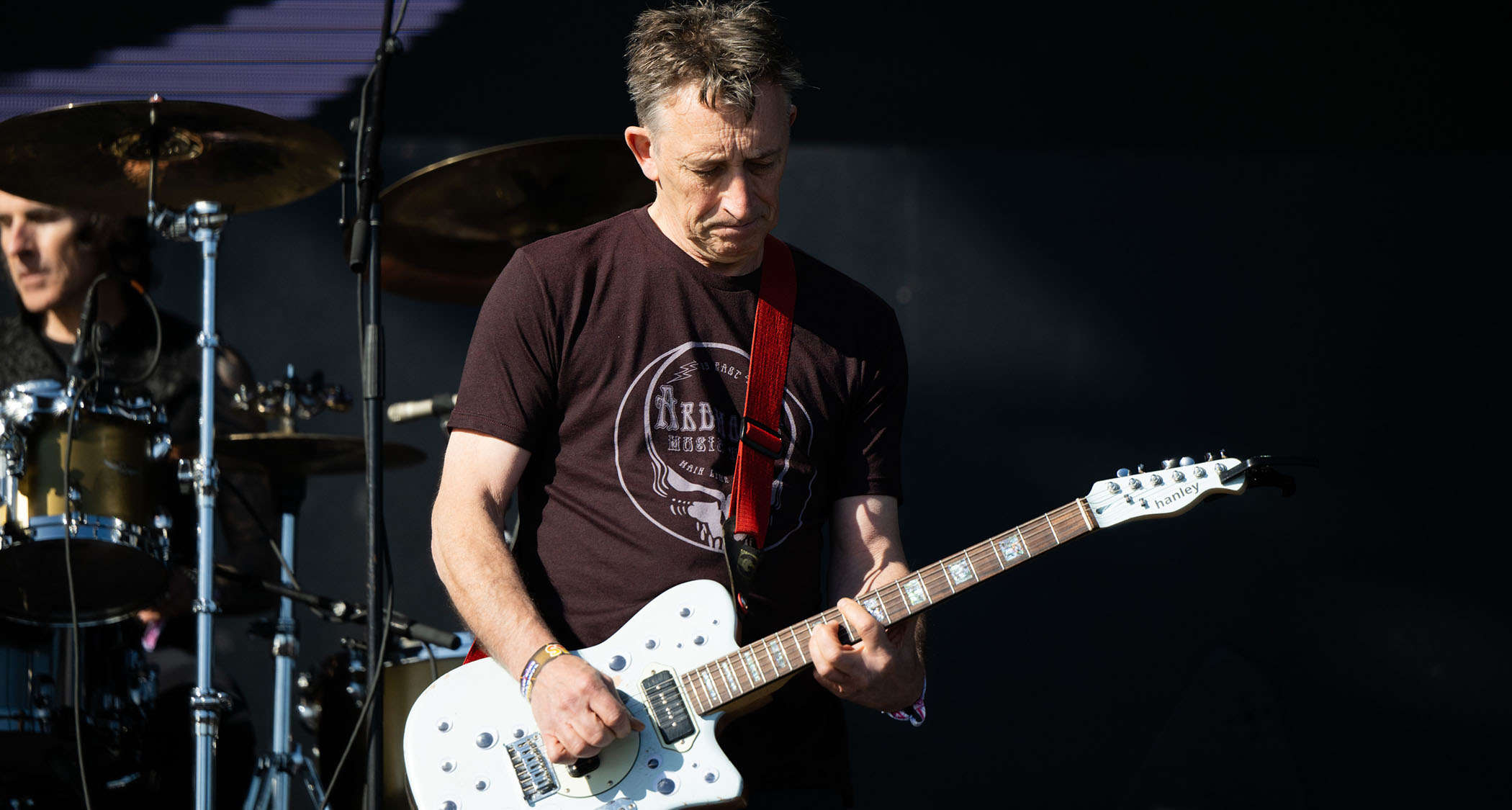 Reg Smithies of the Chameleons performs live in 2023 with a Hanley offset guitar