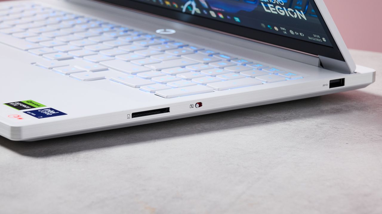 Close-up of right-side ports on Lenovo Legion 7i Gen 10 on desk with pink wall in background