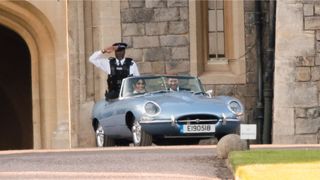 Harry and Meghan driving to their reception in a vintage car.