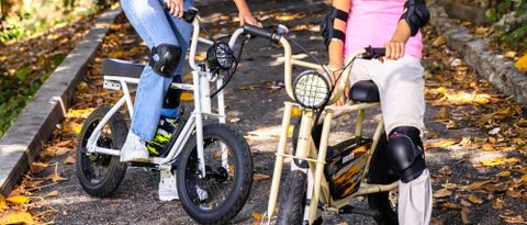 Two children riding Droyd Blipper bikes outside