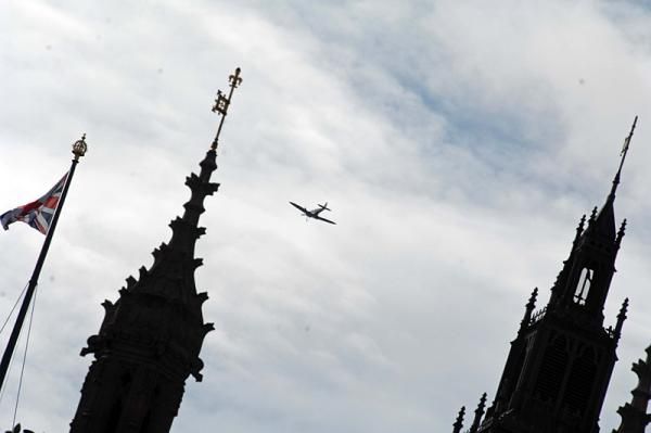 A Spitfire flies past Westminster Abbey to commemorate the Battle of Britain.