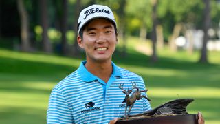 Michael Kim with the 2018 John Deere Classic trophy