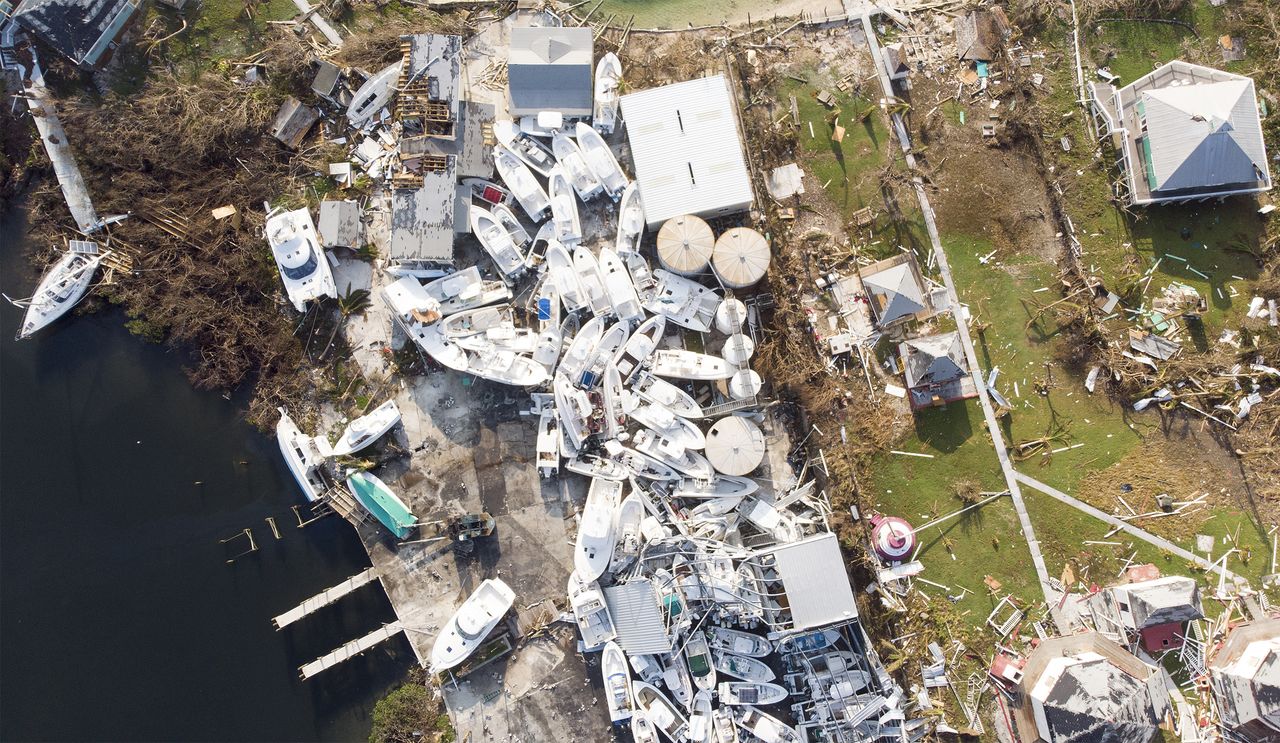 A cluster of boats piled up on land