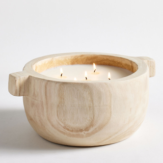 citronella candle in a wood vessel