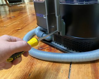 Installing the hose mount on the Kenmore Spotlite portable carpet spot and pet stain cleaner