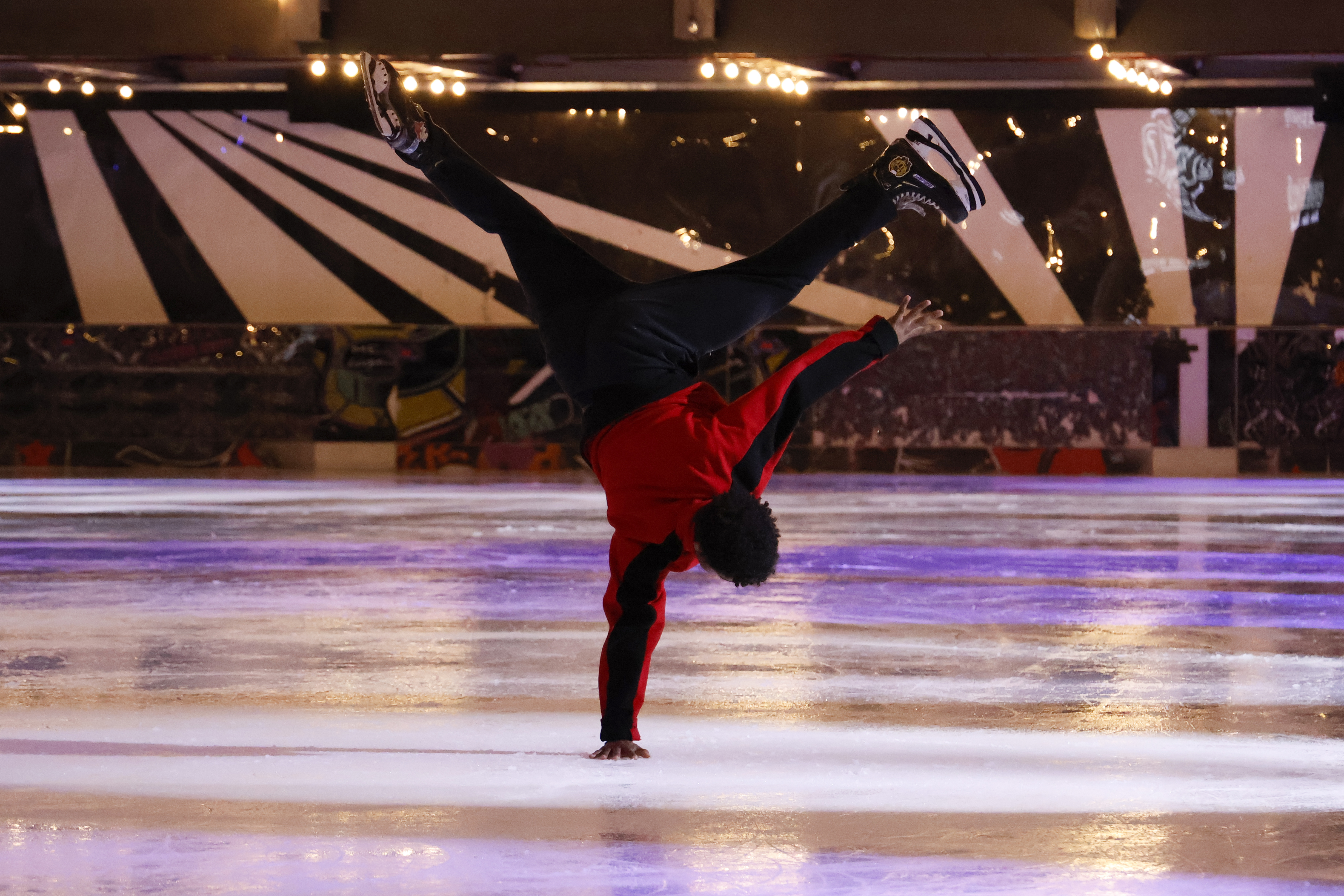 An ice skater performing at an ice rink