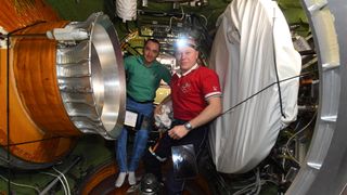 Russian cosmonauts Oleg Novitskiy and Pyotr Dubrov floating inside the Nauka module after opening the hatch to the spacecraft on July 31, 2021.