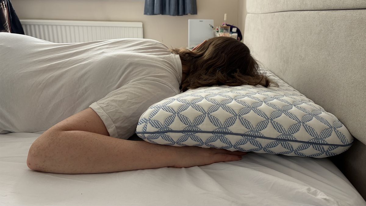 Tester Ruth Jones lies on the Helix Cooling Memory Foam Pillow in her bedroom, in a stomach sleeping position