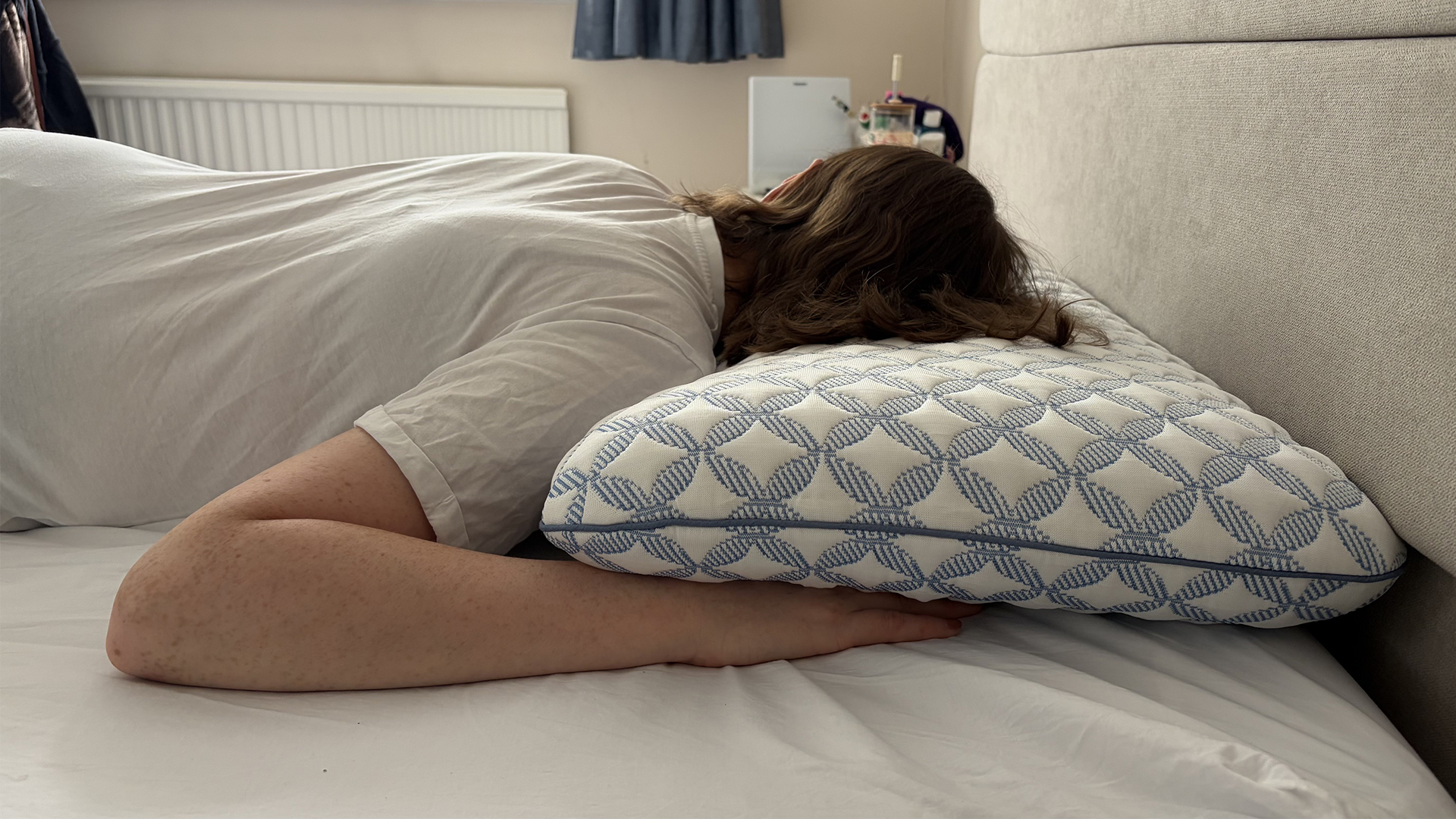 Tester Ruth Jones lies on the Helix Cooling Memory Foam Pillow in her bedroom, in a stomach sleeping position