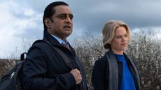 SANJEEV BHASKAR as DI Sunny Khan and SINEAD KEENAN as DCI Jess James stand at Whitney Marsh in Unforgotten season 6