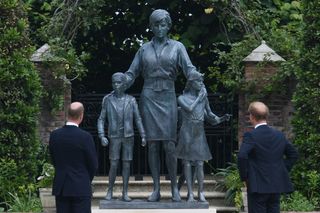 Prince William, Duke of Cambridge (L) and Britain's Prince Harry, Duke of Sussex unveil a statue of their mother, Princess Diana at The Sunken Garden in Kensington Palace