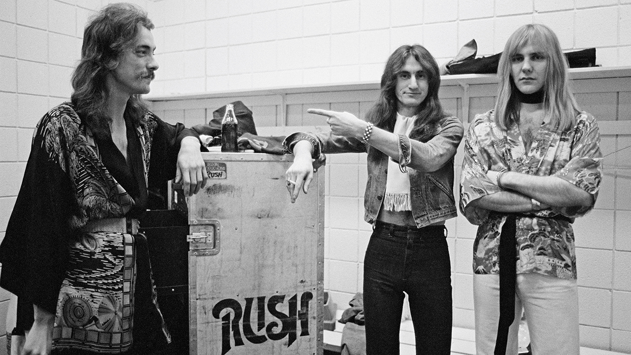 Neil Peart, Geddy Lee and Alex Lifeson from Rush pose backstage in Springfield, Massachusetts, 9th December 1976 during their All The World's a Stage tour. (Photo by Fin Costello/Redferns)