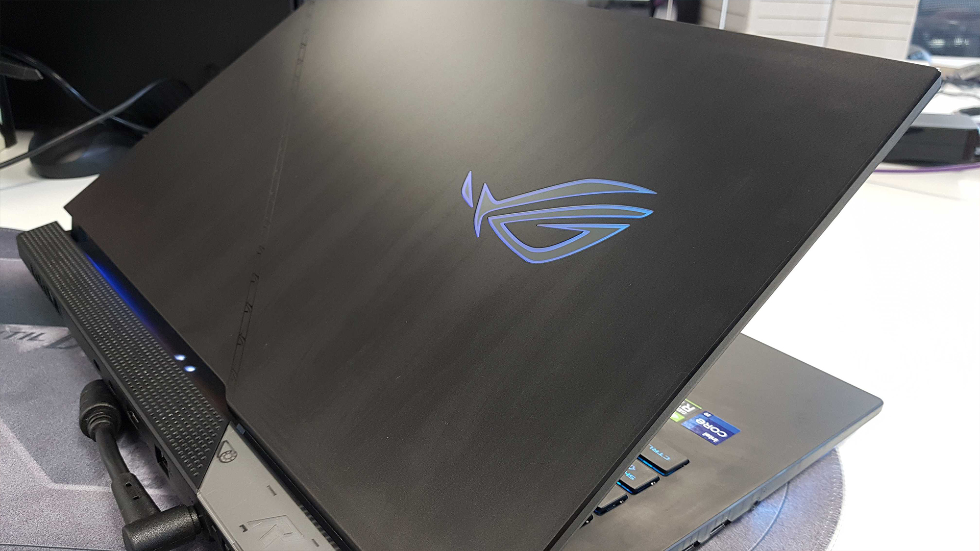 The Asus ROG Strix Scar 17 (2022) from the back on a desk.