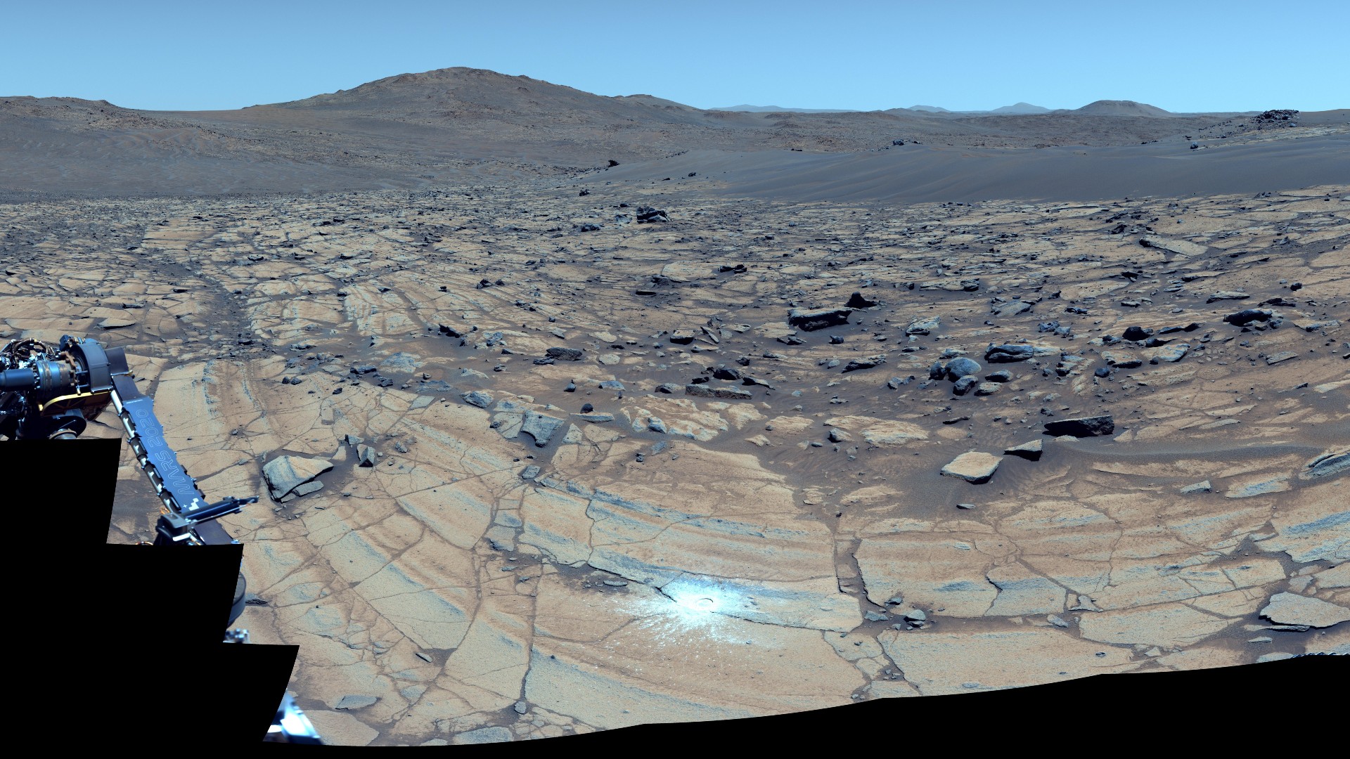 a patch of white powder is visible on a rocky reddish-orange surface