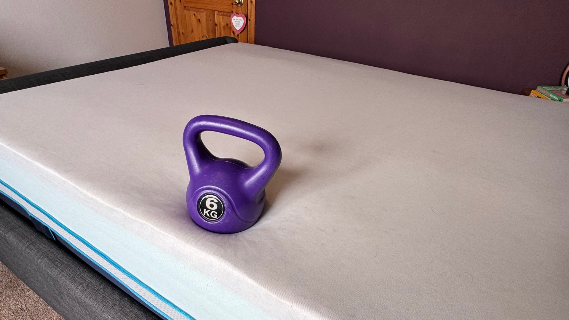 A kettlebell pictured on the Simba Hybrid Luxe Mattress during testing for this review