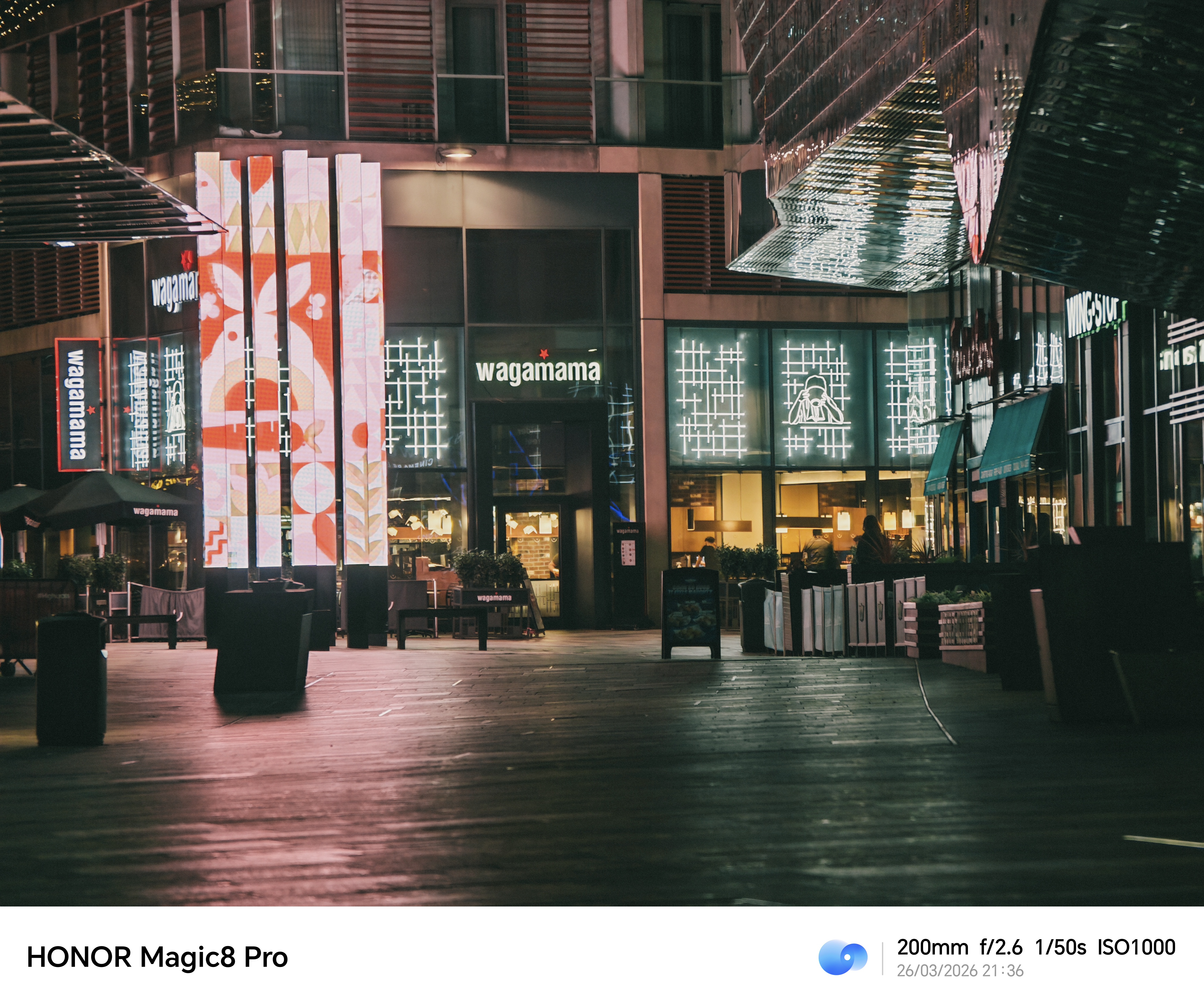 Night street scene outside restaurants, shot on the Honor Magic8 Pro at 200mm